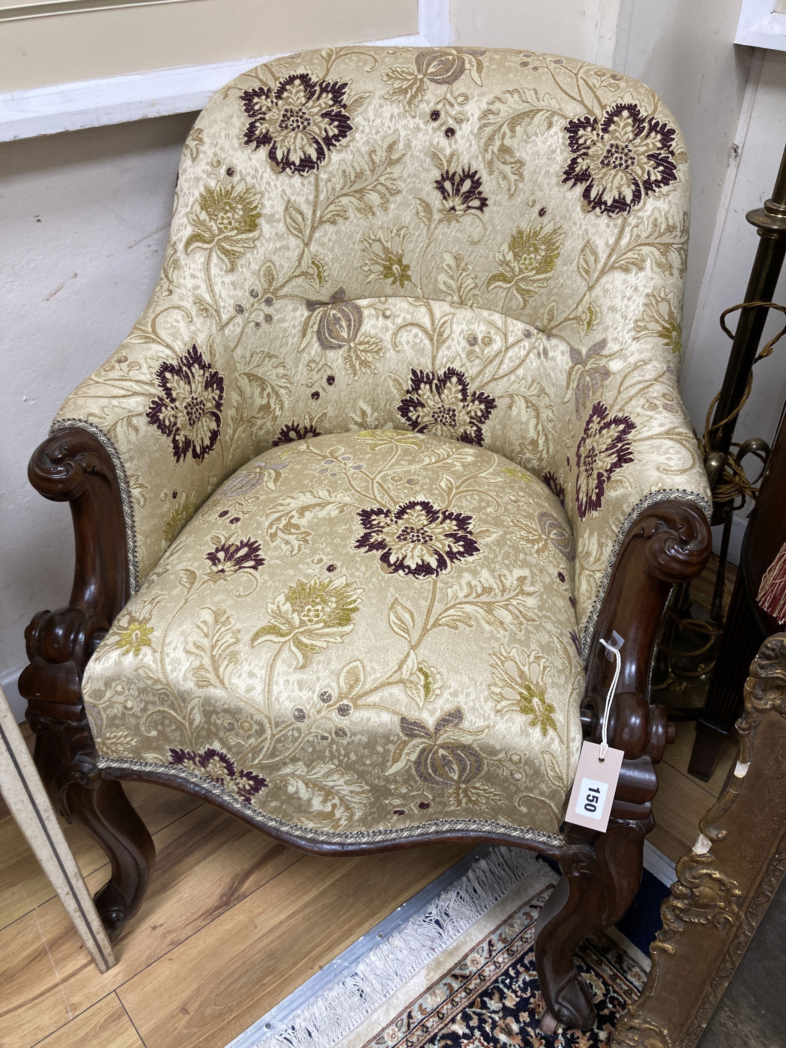 A Victorian upholstered carved mahogany tub chair. W-64, H-86cm.